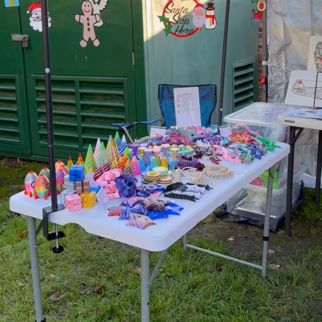 Fidget Toys and Dragons Stall Display Stall display featuring colourful fidget toys and 3D-printed dragons at our market stall