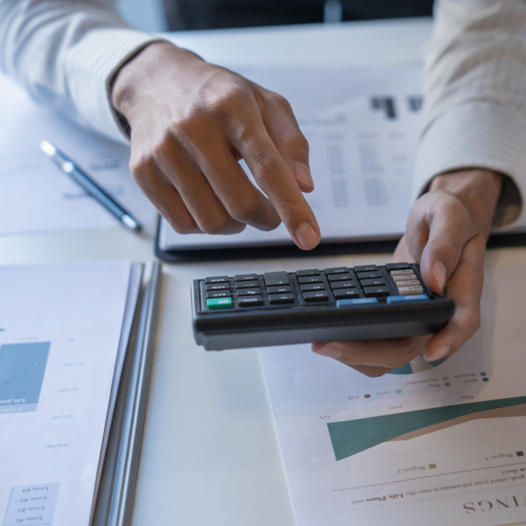 Small business owner using a calculator to assess PPWR compliance costs and EU sales